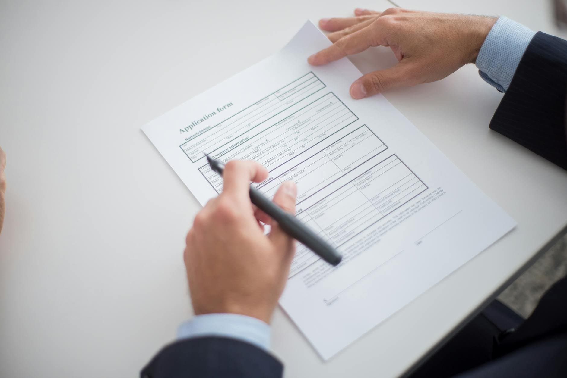 human resources professional reviewing employment documents (Pexels)