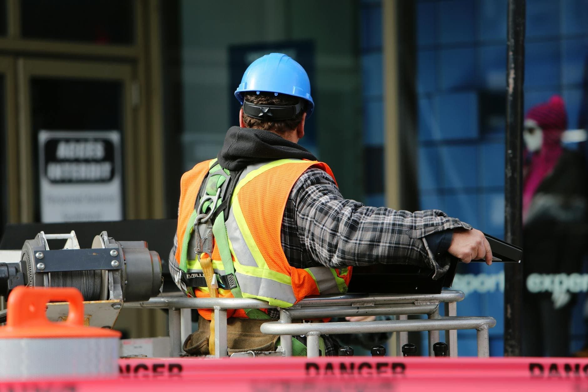 worker wearing high-visibility vest and safety helmet (Pexels)